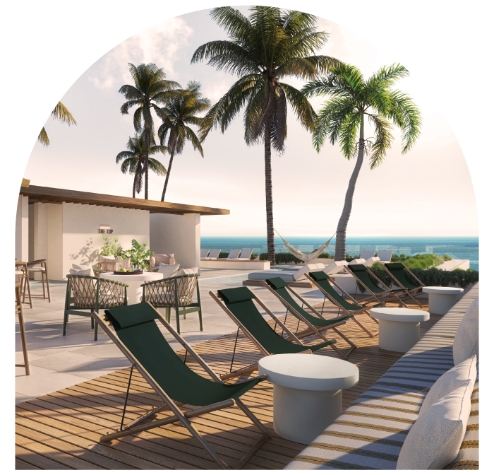 Deck chairs and tables on a terrace with palm trees and ocean view.