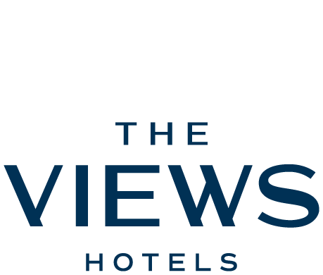 Logo of The Views Hotels with stylized "V" above the text.