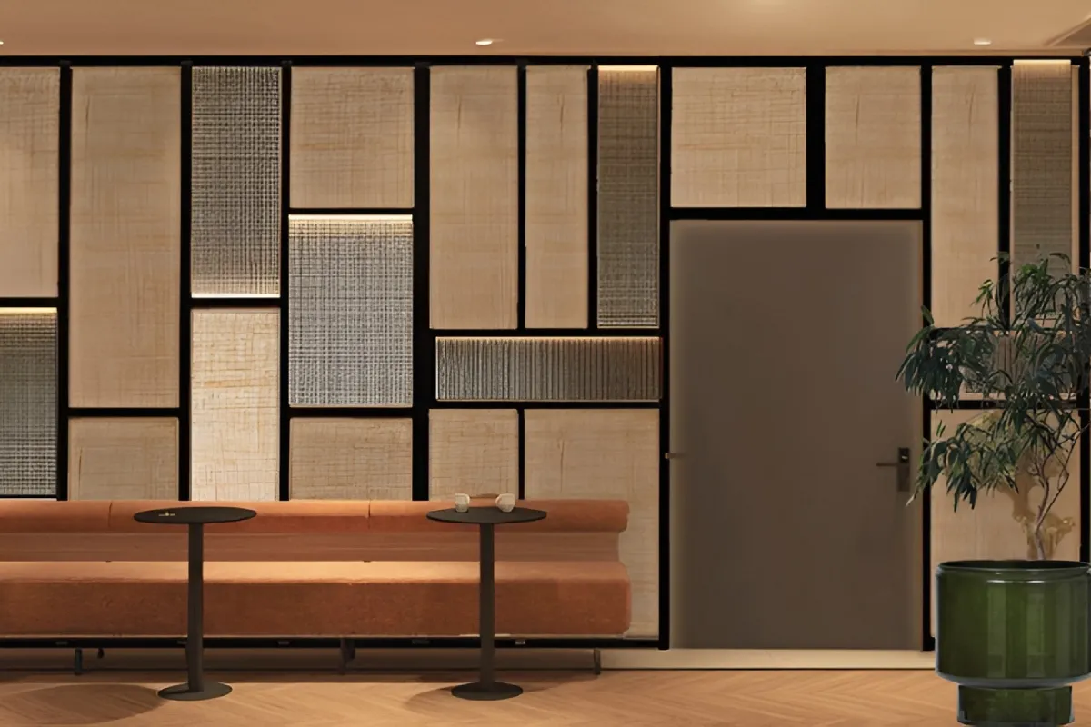 Modern lounge with geometric wall panels and a brown bench.