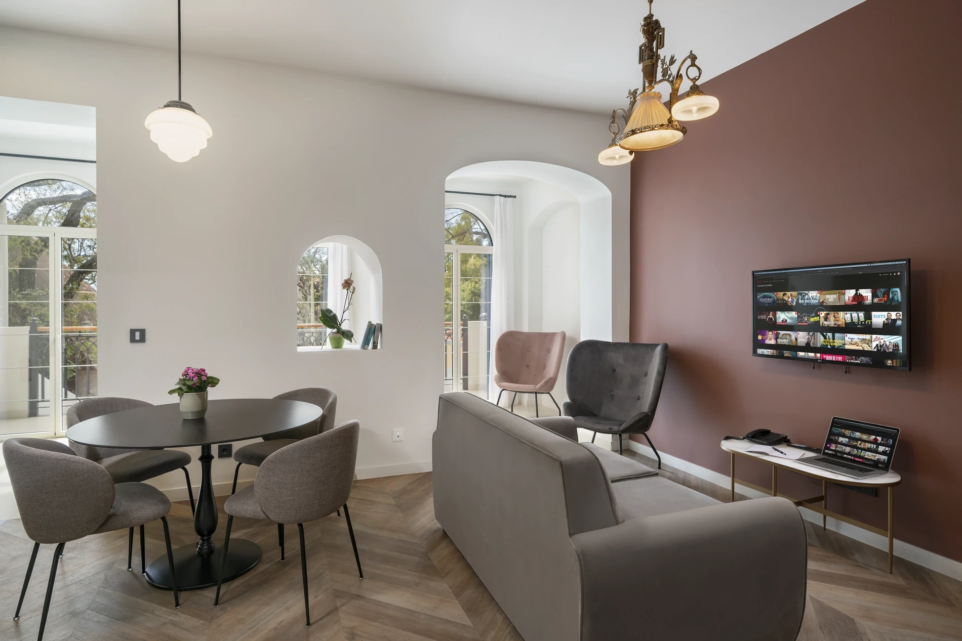 Modern living room with TV, sofa, chairs, and dining table.