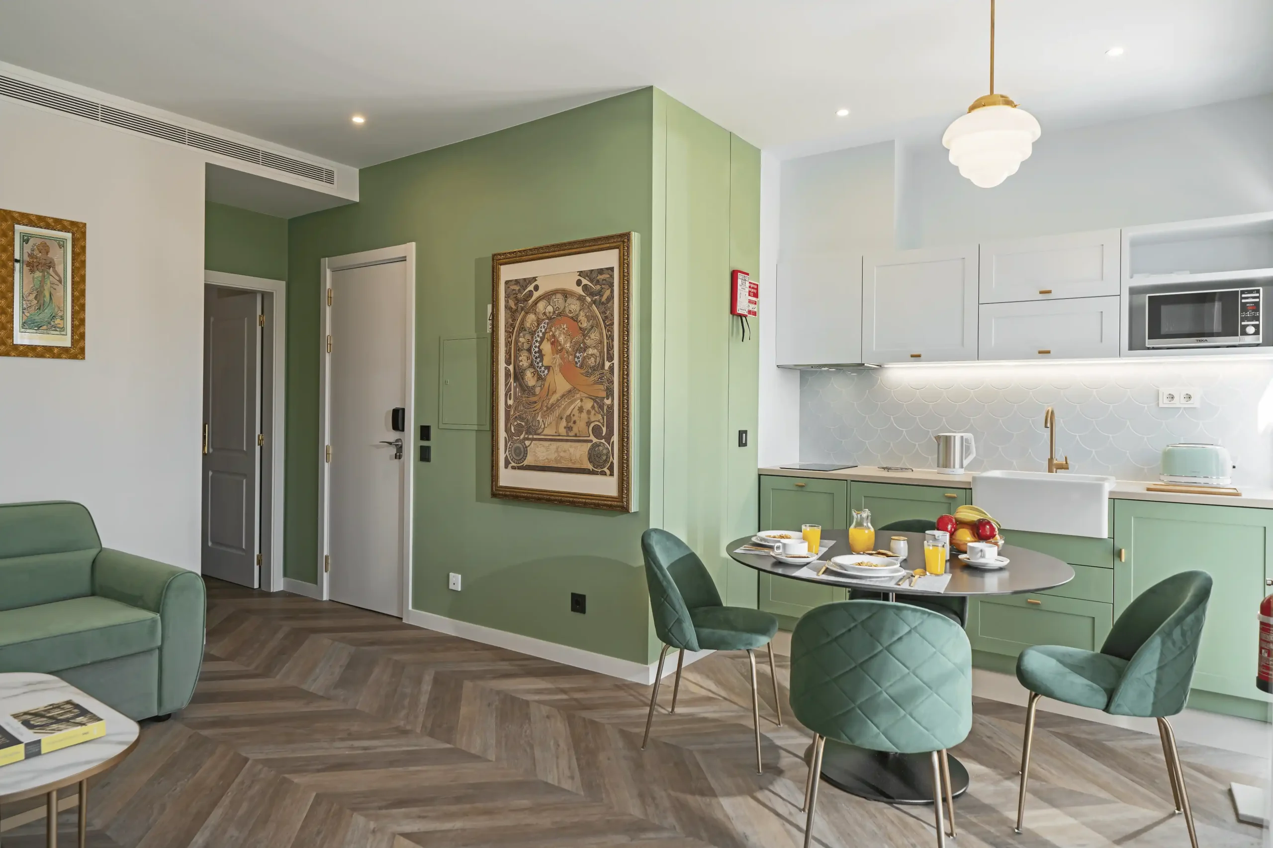 Stylish kitchen and dining area with green accents and modern decor.