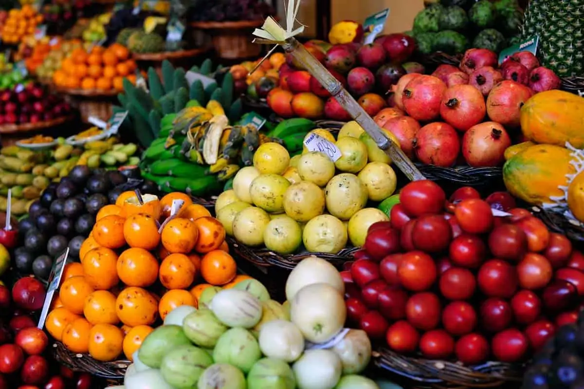 Baskets of colorful fruits in a market display.