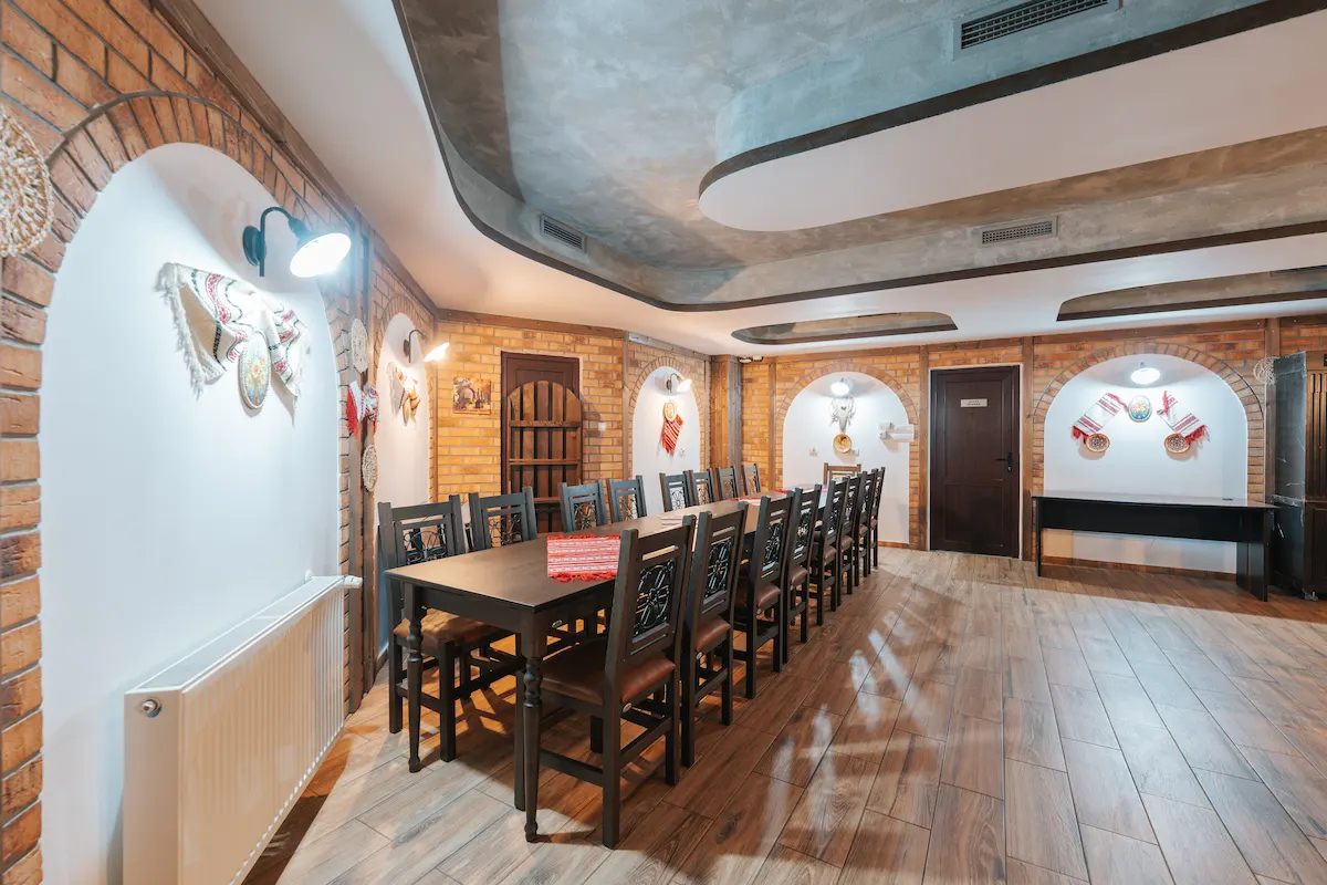 Rustic dining room with long table and brick accents.