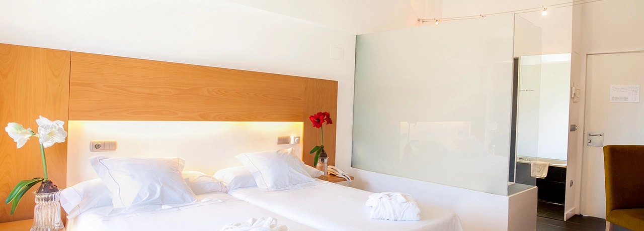 Habitación de hotel moderna con camas individuales y decoración minimalista.