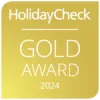 "Premio HolidayCheck Oro 2024 en fondo dorado."