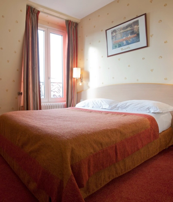 Chambre d'h&ocirc;tel avec lit double, tableau et fen&ecirc;tre avec rideaux.