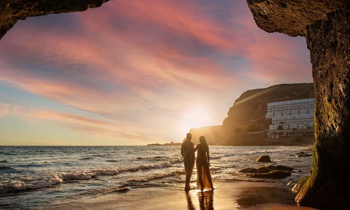 A couple enjoying sunset on Taurito Beach during a luxury romantic getaway at Princess Taurito (Gran Canaria)
