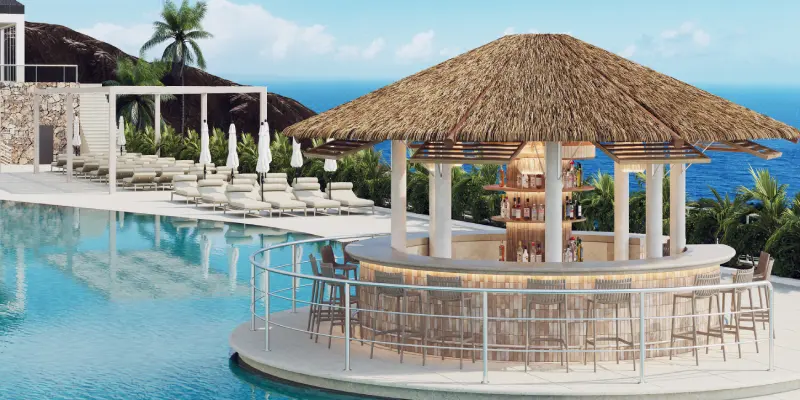 Piscina y bar al aire libre con techo de palma junto al mar.