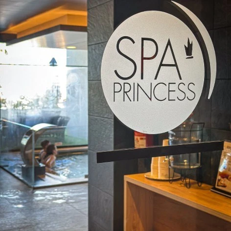 Cartel &ldquo;SPA PRINCESS&rdquo; en la entrada de un spa con zona de vapor y caf&eacute;