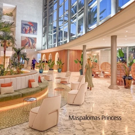 Lobby del hotel Maspalomas Princess con muebles y palmeras bajo luz natural