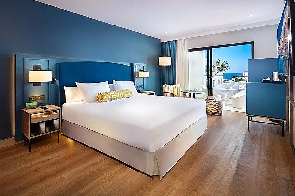 Habitaci&oacute;n de hotel moderna con cama y vista al exterior por la ventana