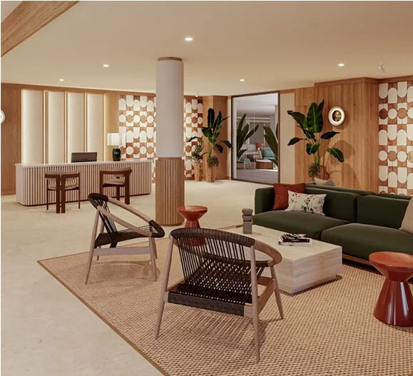 Sala moderna con sillones verdes, mesas de madera y decoraci&oacute;n c&aacute;lida.