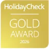 Premio HolidayCheck Gold Award 2026, fondo dorado.