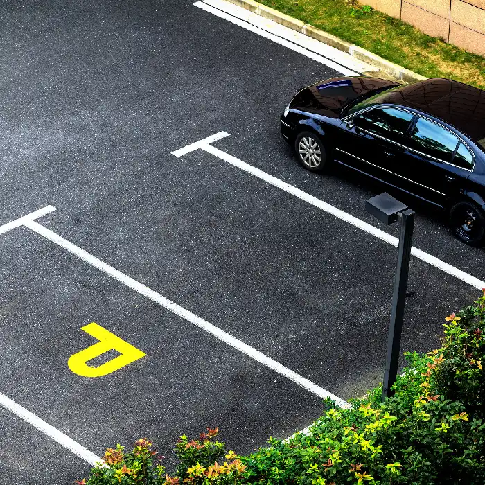 Coches en la entrada; flechas y se&ntilde;ales de carril pintadas en el asfalto