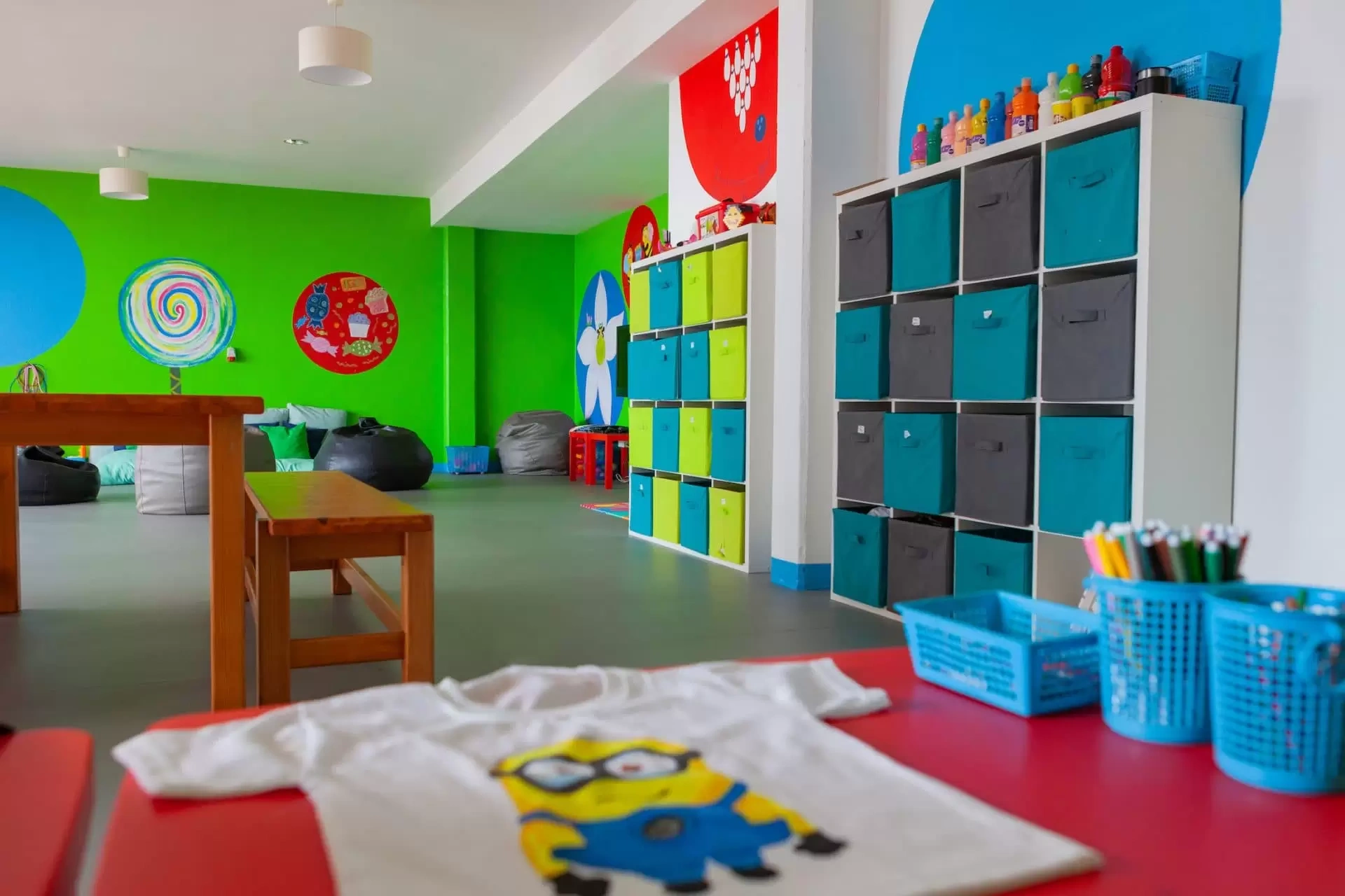 Colorful kids' playroom with storage cubbies and art supplies.
