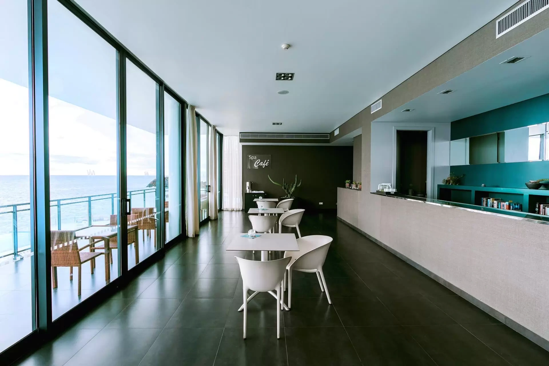 Modern caf&eacute; with ocean view and glass walls.