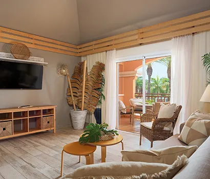 Cozy living room with tropical decor and sliding door to balcony.