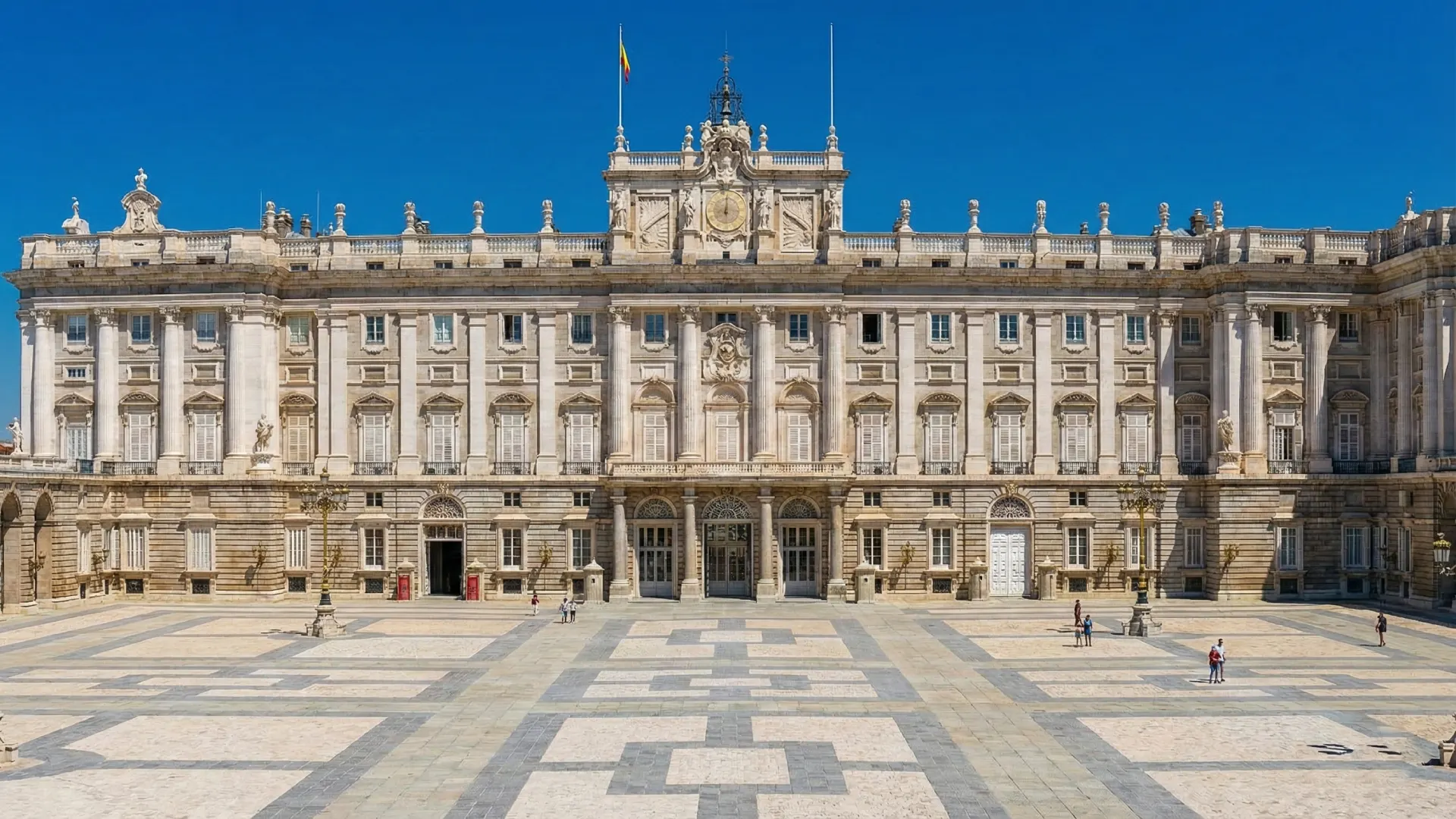 Palacio real con una gran plaza frontal y cielo despejado.