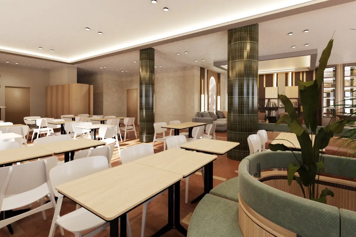 Interior moderno de cafetería con mesas, sillas y columnas metálicas.