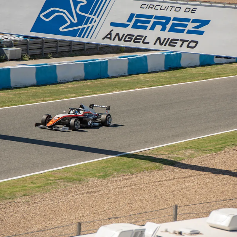 Auto de F&oacute;rmula 1 en pista en el circuito Jes&uacute;s &Aacute;ngel Nieto, con cartel al fondo