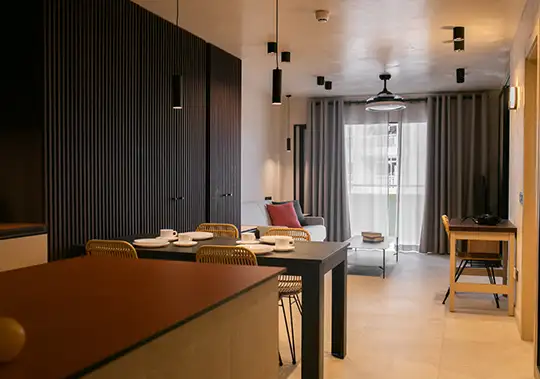 Modern apartment with dining area, living room, and large windows.