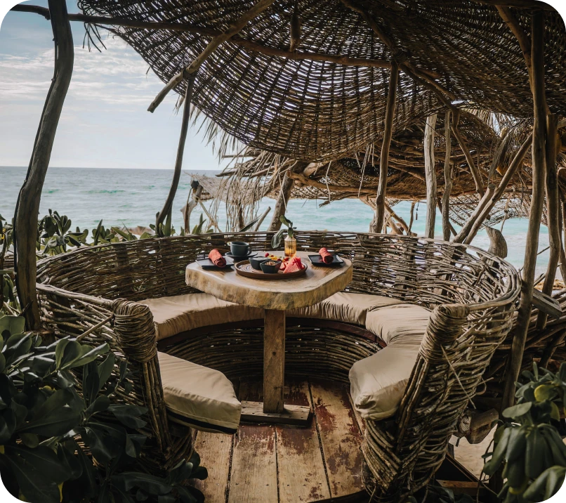 Cozy beachside wicker seating with snacks and ocean view.