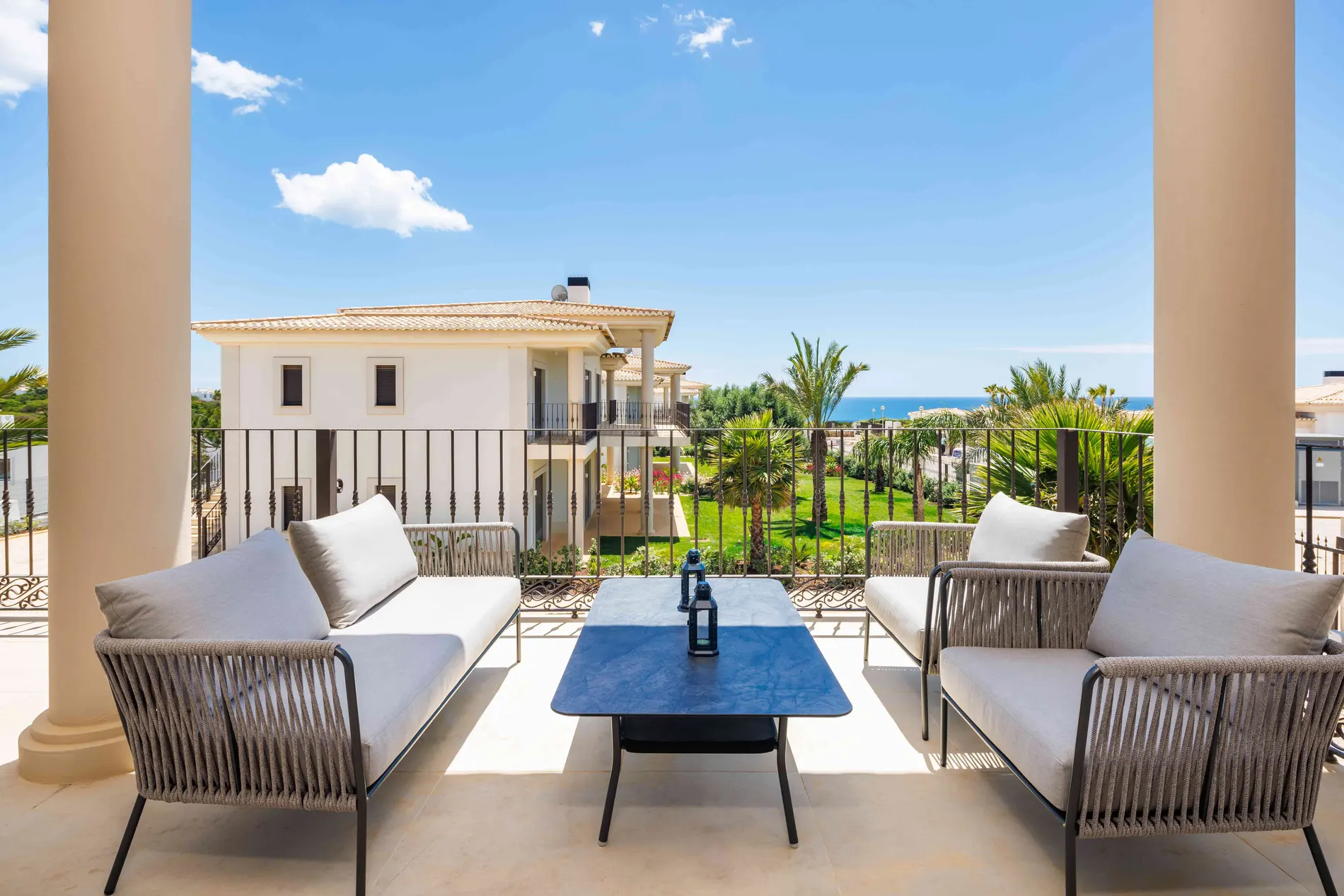 Terrace view with seating area overlooking garden and ocean.