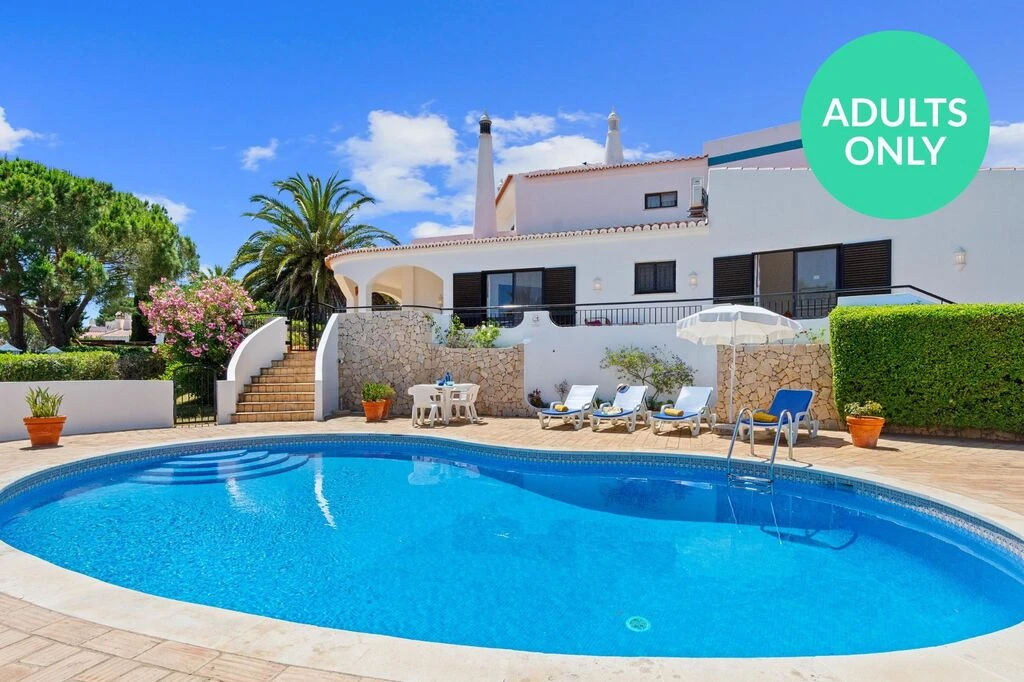 House with pool, palm trees, and "Adults Only" sign.