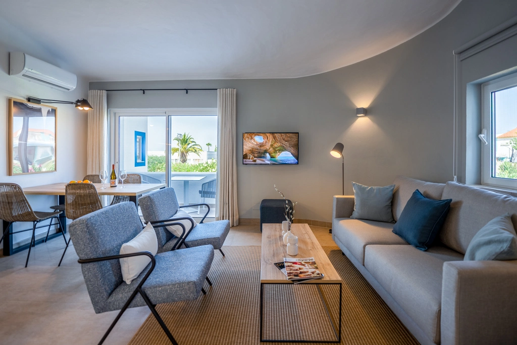 Modern living room with cozy seating, dining area, and a view outside.