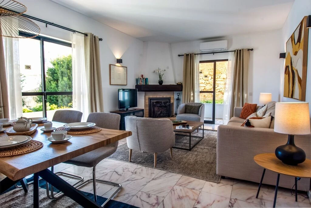 Cozy living and dining area with natural light and modern furnishings.