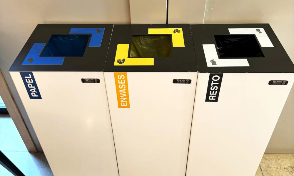 Tres contenedores de reciclaje: papel, envases y resto.