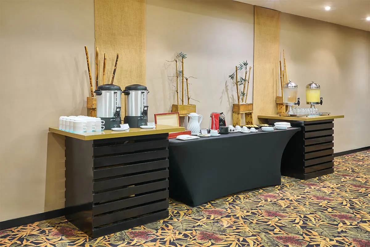 Hotel buffet station with coffee urns, tea server, and drink dispensers