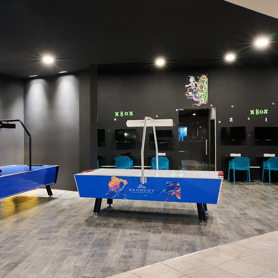 Xbox-themed arcade room with foosball table and neon lights