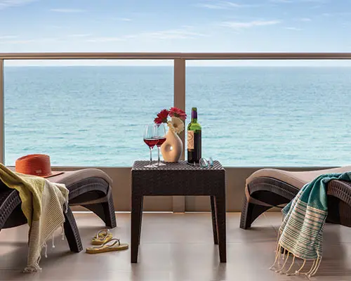 Patio table set with wine and drinks overlooking the ocean sea view