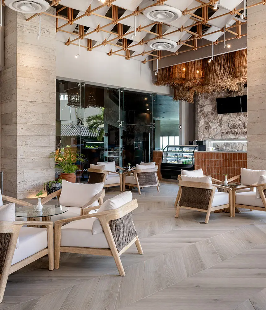 Outdoor resort lounge with wooden chairs and pendant lights under a canopy