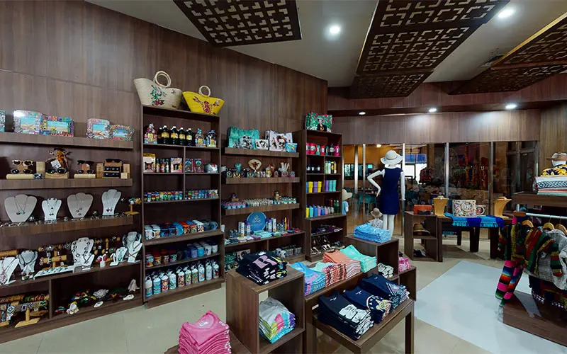 Gift shop interior with shelves of colorful merchandise and clothing displays