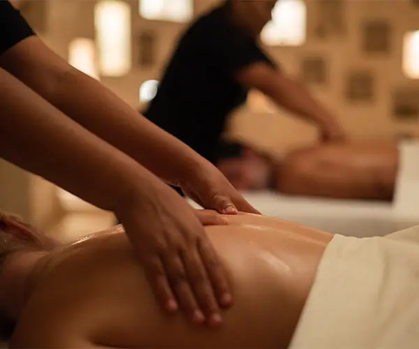 Massage therapist&rsquo;s hands giving a relaxing back massage to a client
