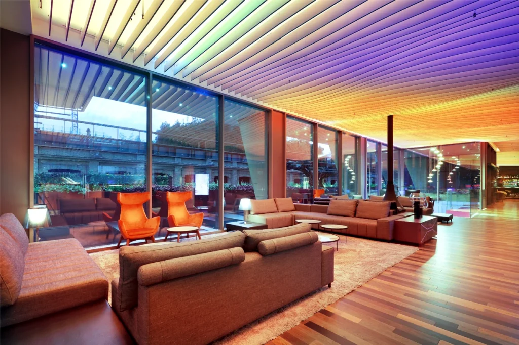 A modern living room featuring colorful lighting and stylish furniture.
