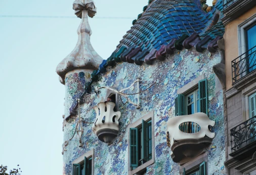 Fachada modernista azul con motivos escult&oacute;ricos y balcones en Barcelona