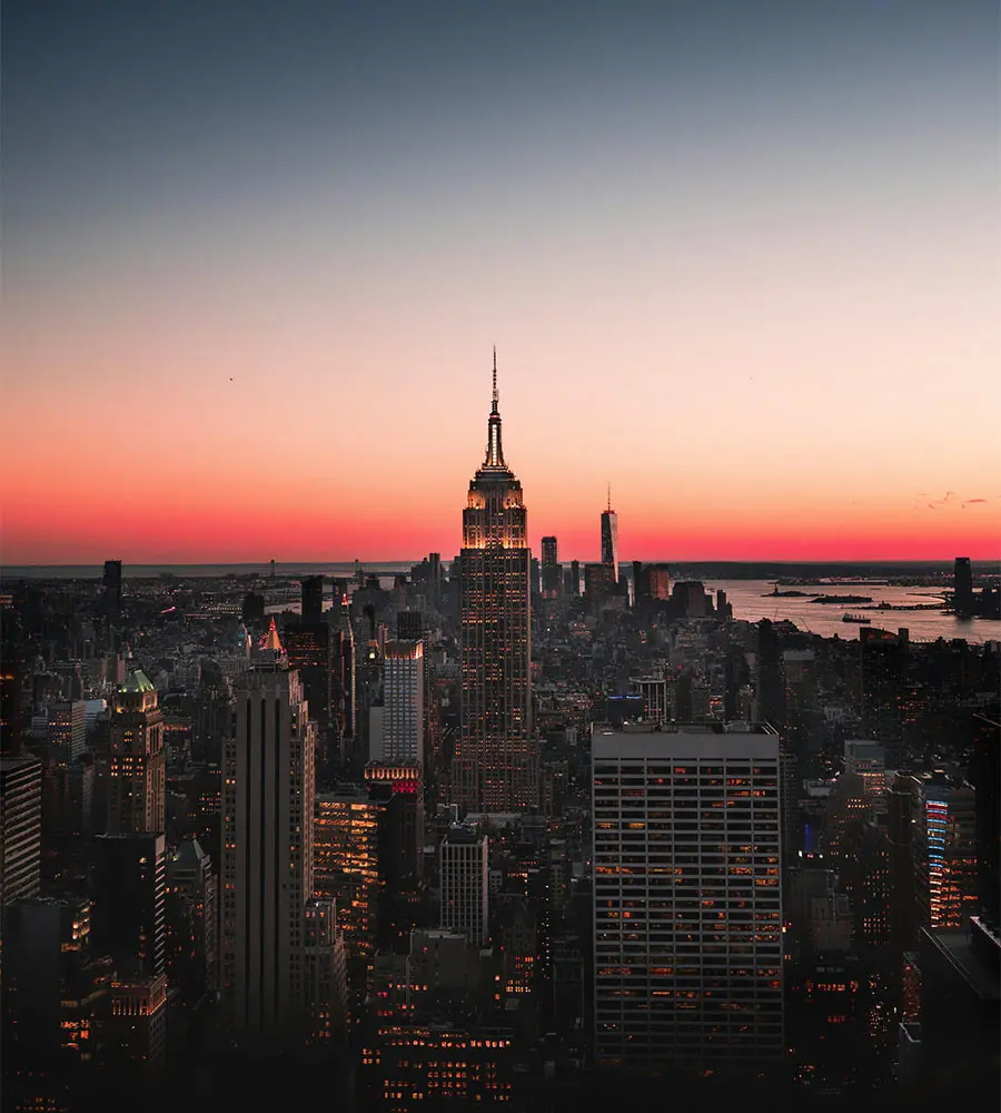 New York City skyline at sunset with the Empire State Building glowing in dusk