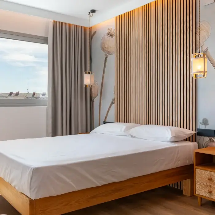 Dormitorio moderno con cama blanca, cortinas grises y pared de listones madera