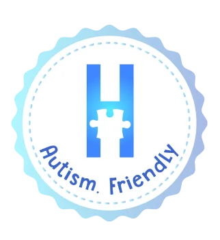 Sello &ldquo;Autism Friendly&rdquo; con icono de rompecabezas azul en c&iacute;rculo.