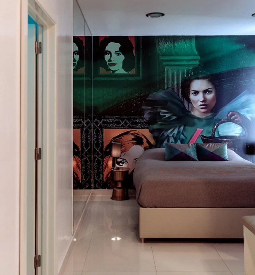 Modern bedroom with graphic wall art and a made bed in muted colors