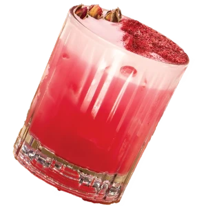 Slice of red cocktail drink in a clear glass with a sugar rim