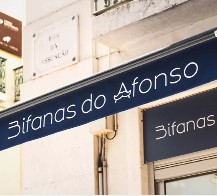 Street storefront sign reading &ldquo;Bifanas do AfonsO&rdquo; and &ldquo;Bifanas&rdquo; in Lisbon