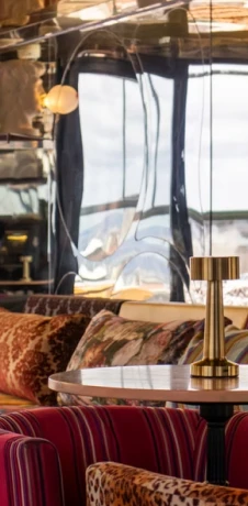 Luxury interior lounge with leather seating and gold lamp near windows