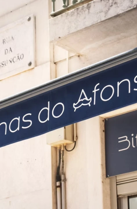 Store sign reading &ldquo;Afons&rdquo; above a street doorway in Portugal