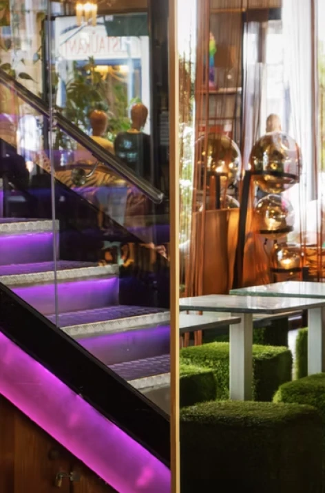 Outdoor patio with purple light staircase and decorative lanterns in window