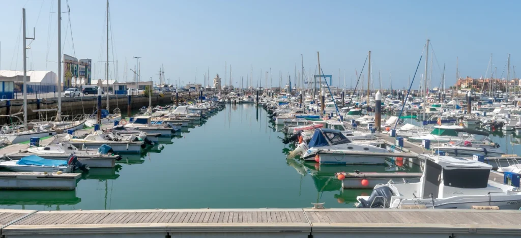 Puerto deportivo con yates y botes amarrados en un canal tranquilo