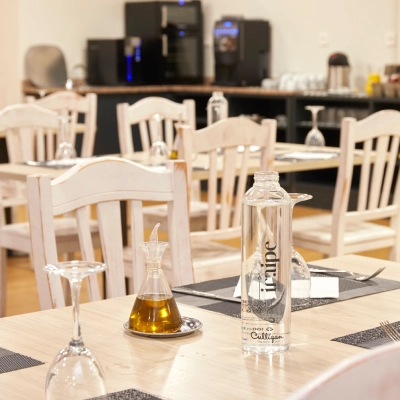 Mesas con recipientes de laboratorio y botellas en un sal&oacute;n con sillas